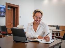 A Bachelor of Arts in Liberal Studies student smiling while working in a virtual advising appointment